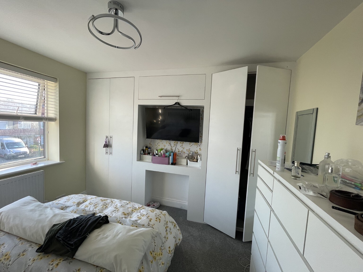 Wall-to-wall fitted bedroom wardrobes and media storage