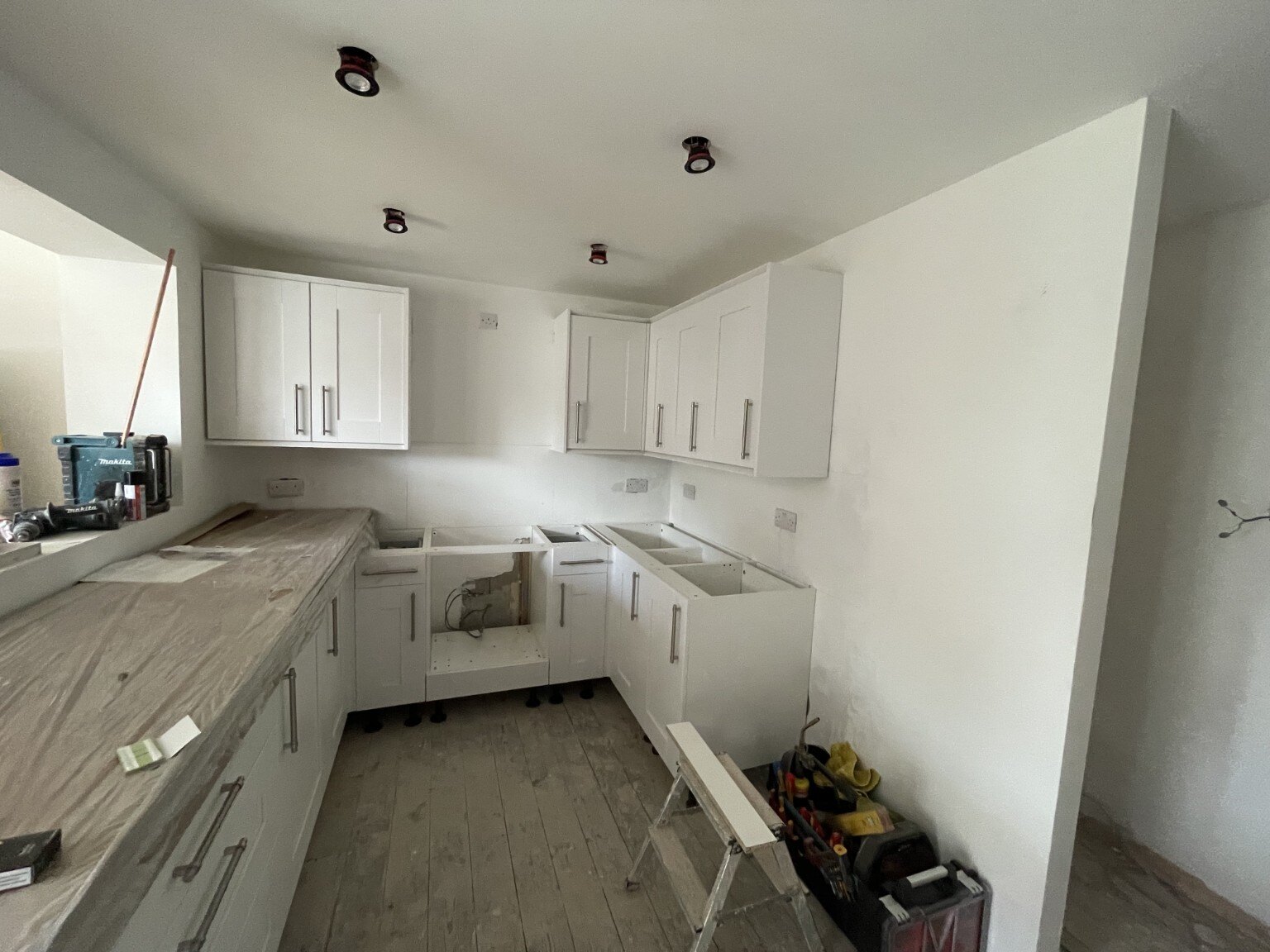 Wall and base cabinets being installed during a Bognor Regis kitchen refurbishment