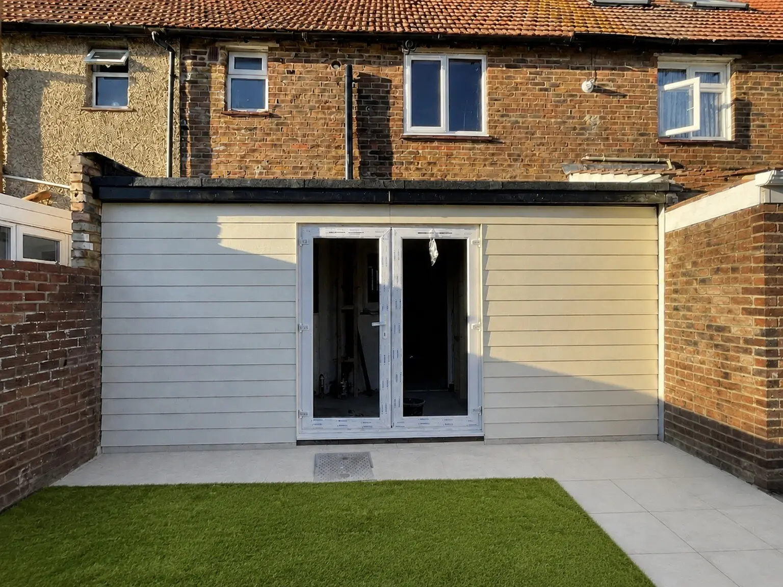 Completed Bognor Regis rear extension with cladding, patio doors and landscaped garden