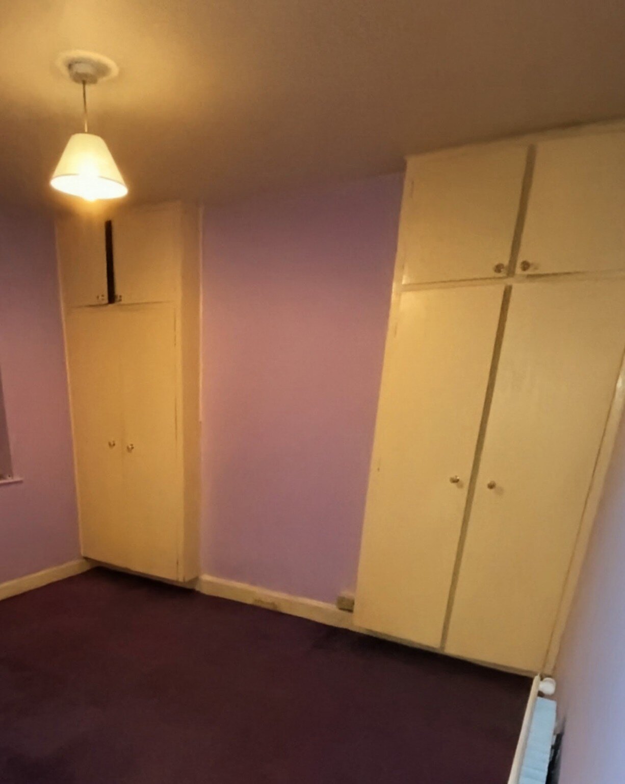 Existing cream bedroom cupboards before bespoke fitted wardrobe work
