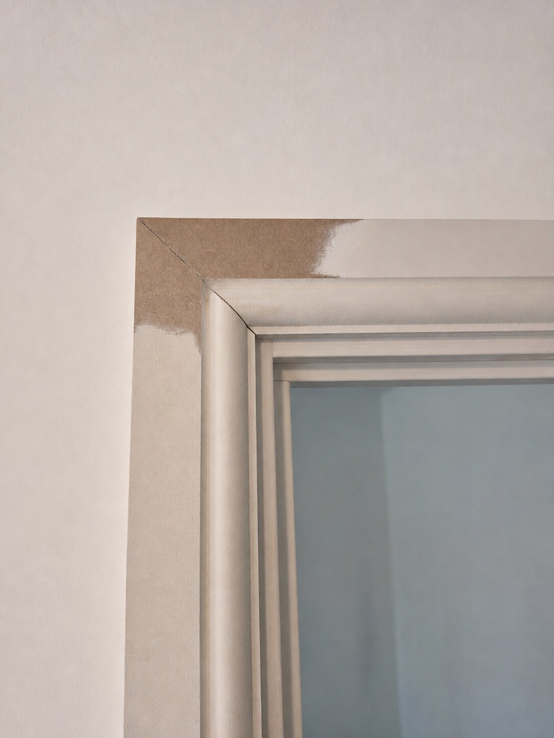 Close-up of the mitred corner of a profiled door architrave