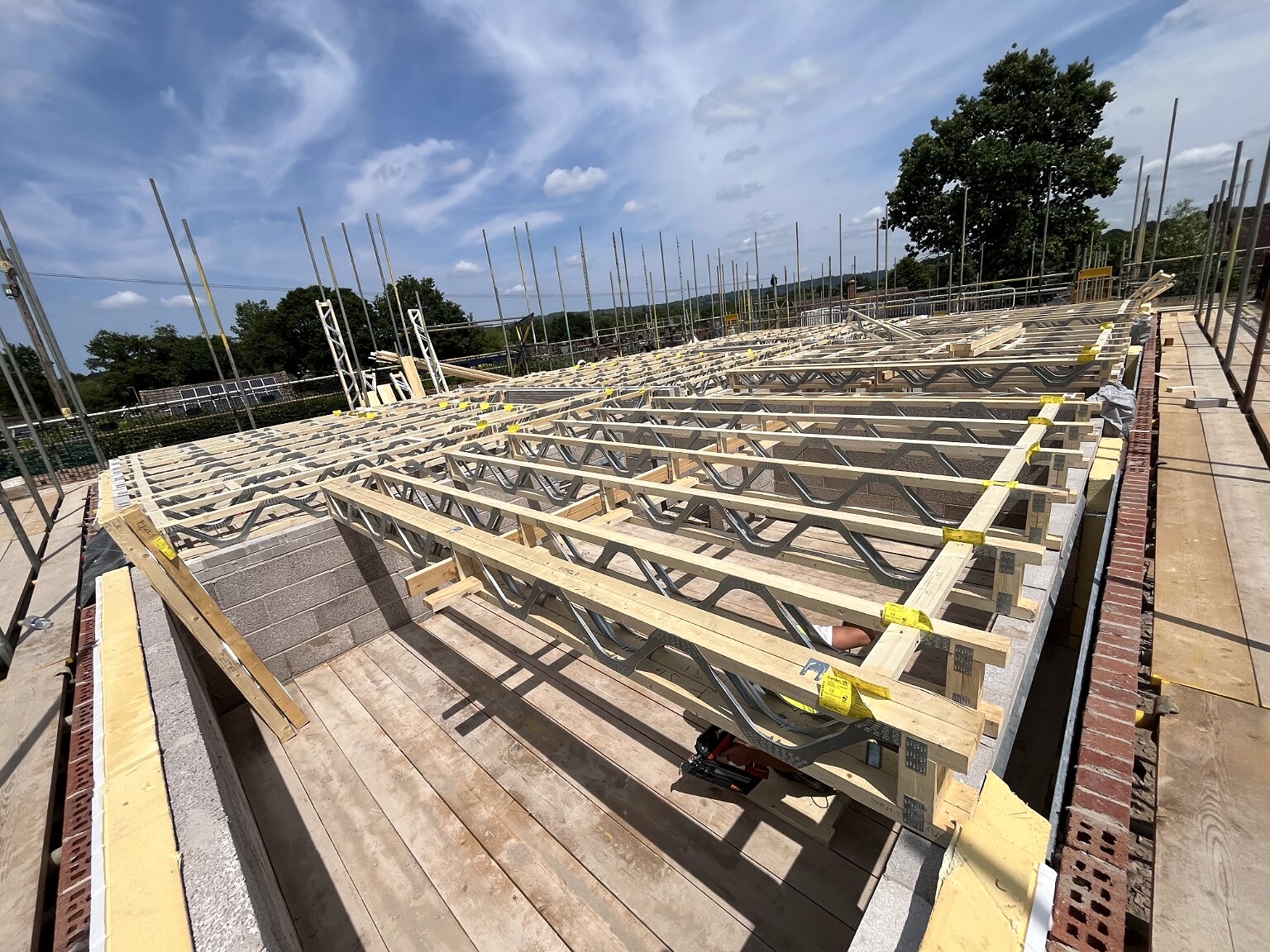 Metal-web joists prepared for services and decking