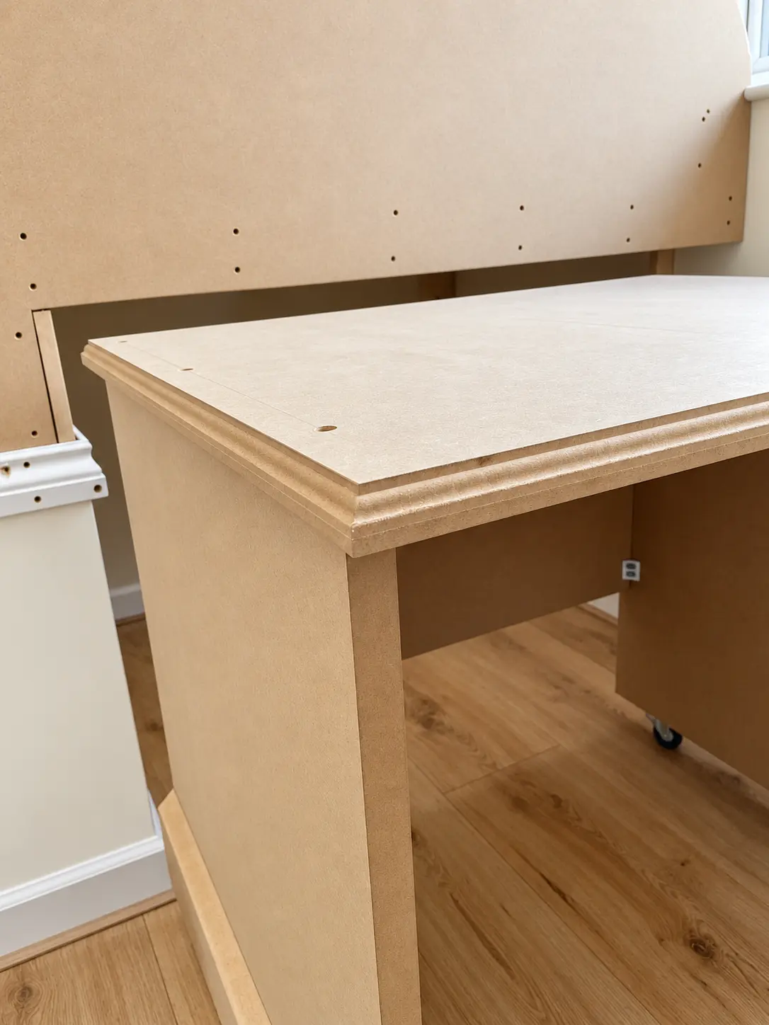 Close view of the bespoke pull-out MDF desk and supporting cabinet