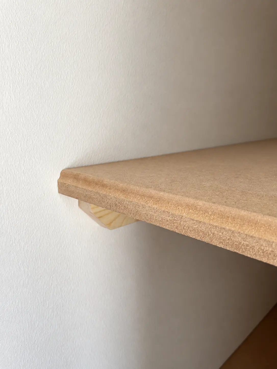 Close-up of shaped MDF wall shelf