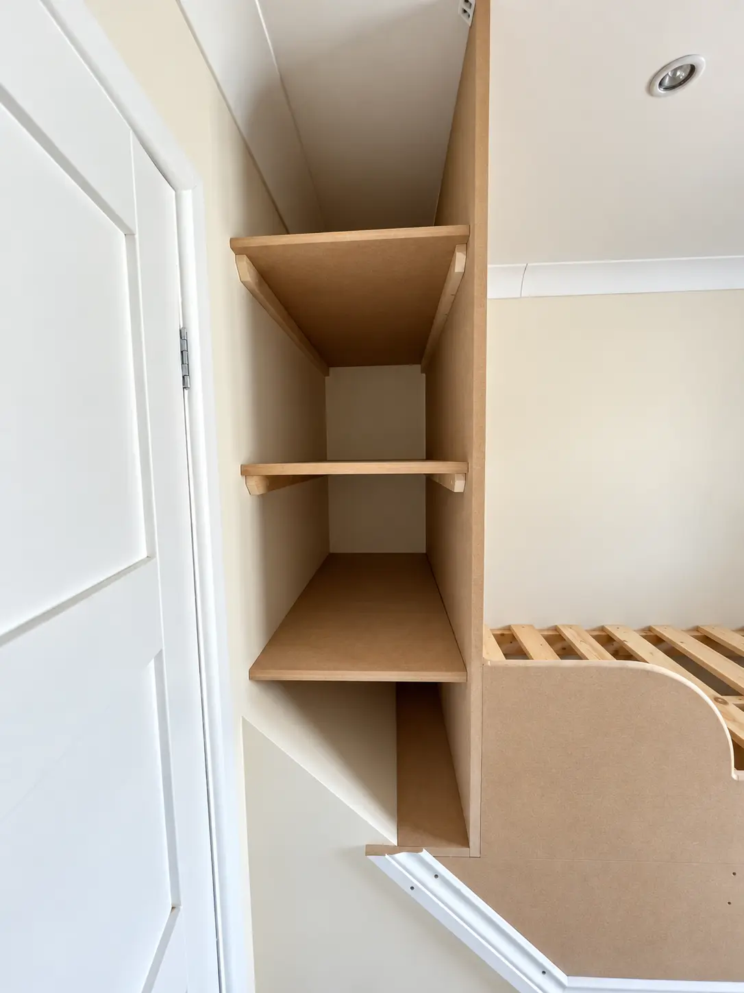 Raised bed with integrated shelving in an Emsworth bedroom