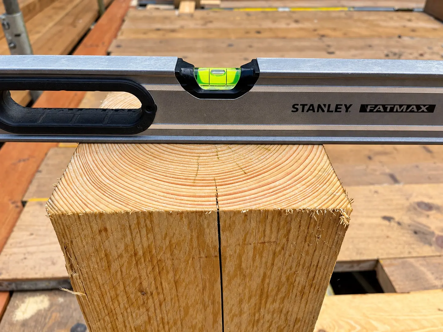 Stanley spirit level showing a roof timber checked true during installation