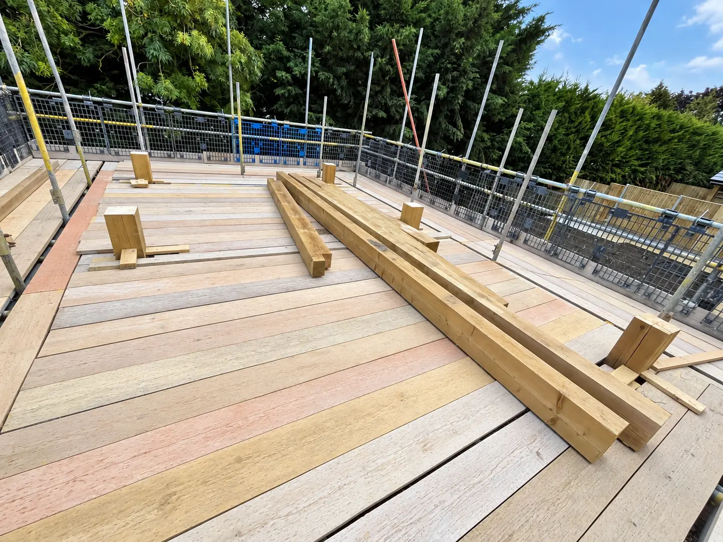Structural roof timbers laid out on the upper floor deck