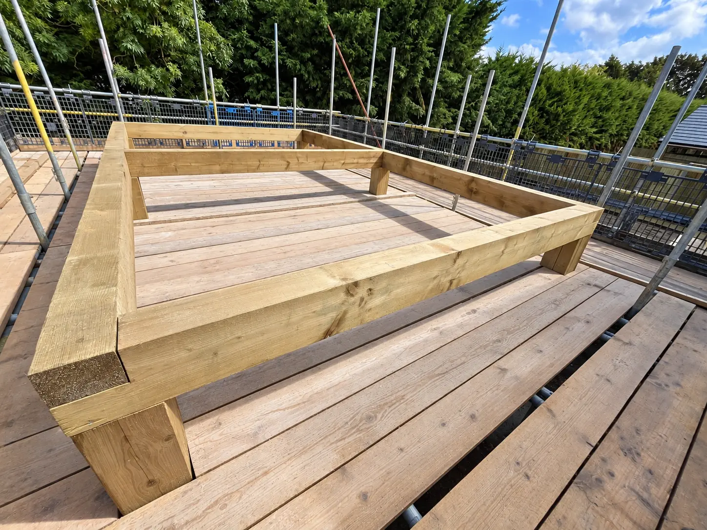 Perimeter roof timbers assembled on the deck before truss installation