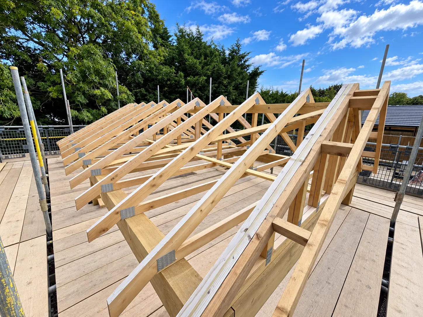 Second view across installed roof trusses and gable framing