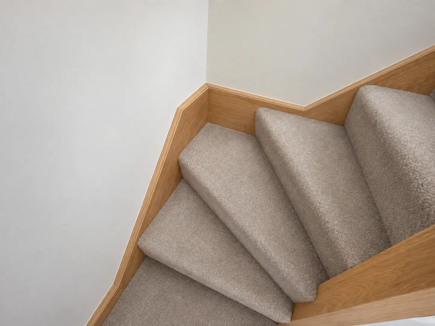 Light-oak finish around the carpeted winder treads