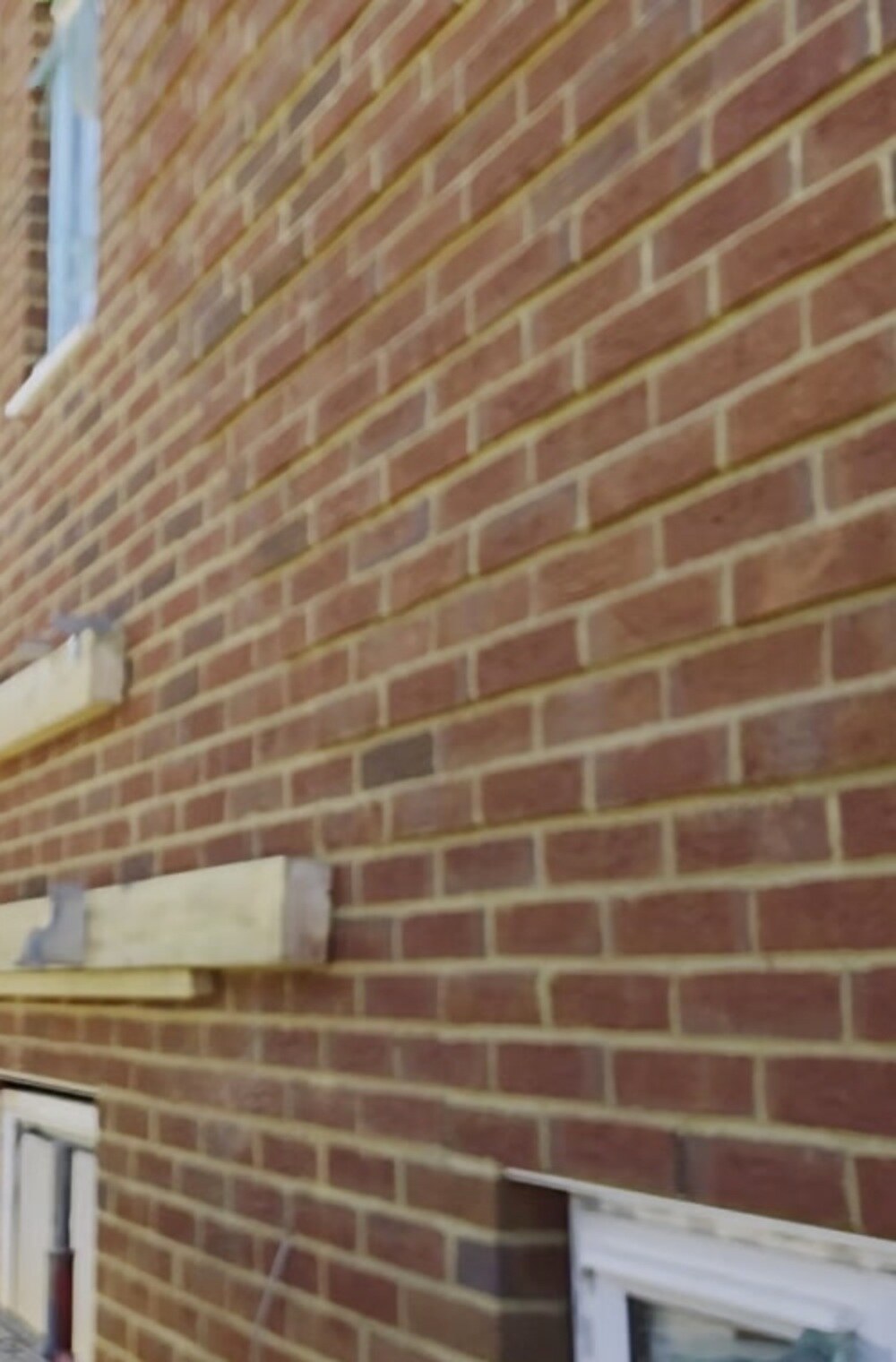 Two timber wall plates fixed to brickwork for a cantilever front-door canopy in Wick, Littlehampton