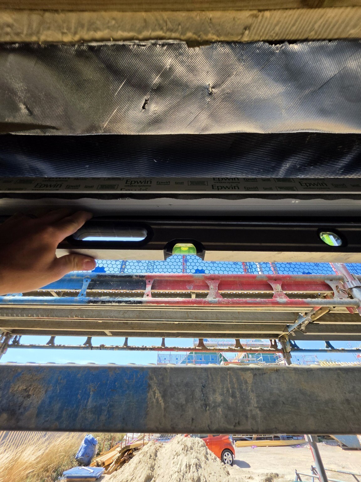 Alignment checked across the head of a new front-door frame in Wick, Littlehampton